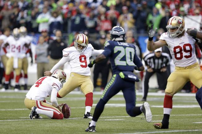 San Francisco 49ers' Phil Dawson (9) works against the Seattle Seahawks  during the first half of the NFL football NFC Championship game Sunday, Jan. 19, 2014, in Seattle. (AP Photo/Elaine Thompson)